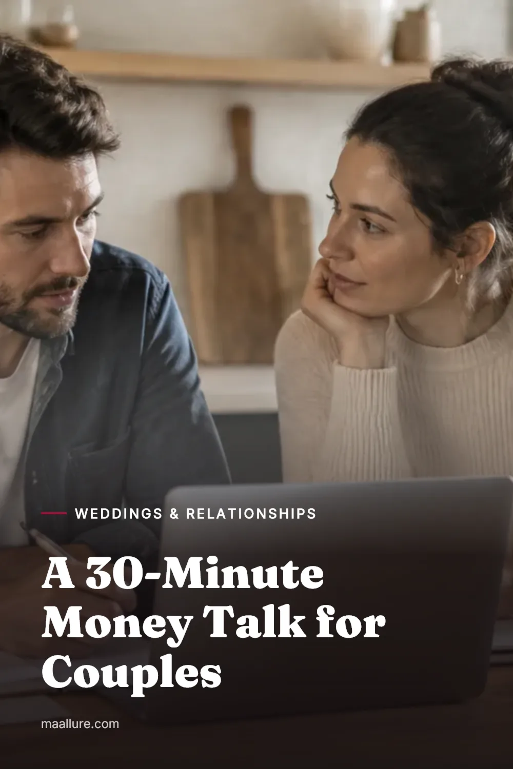 Couple sitting together at a kitchen table reviewing finances calmly