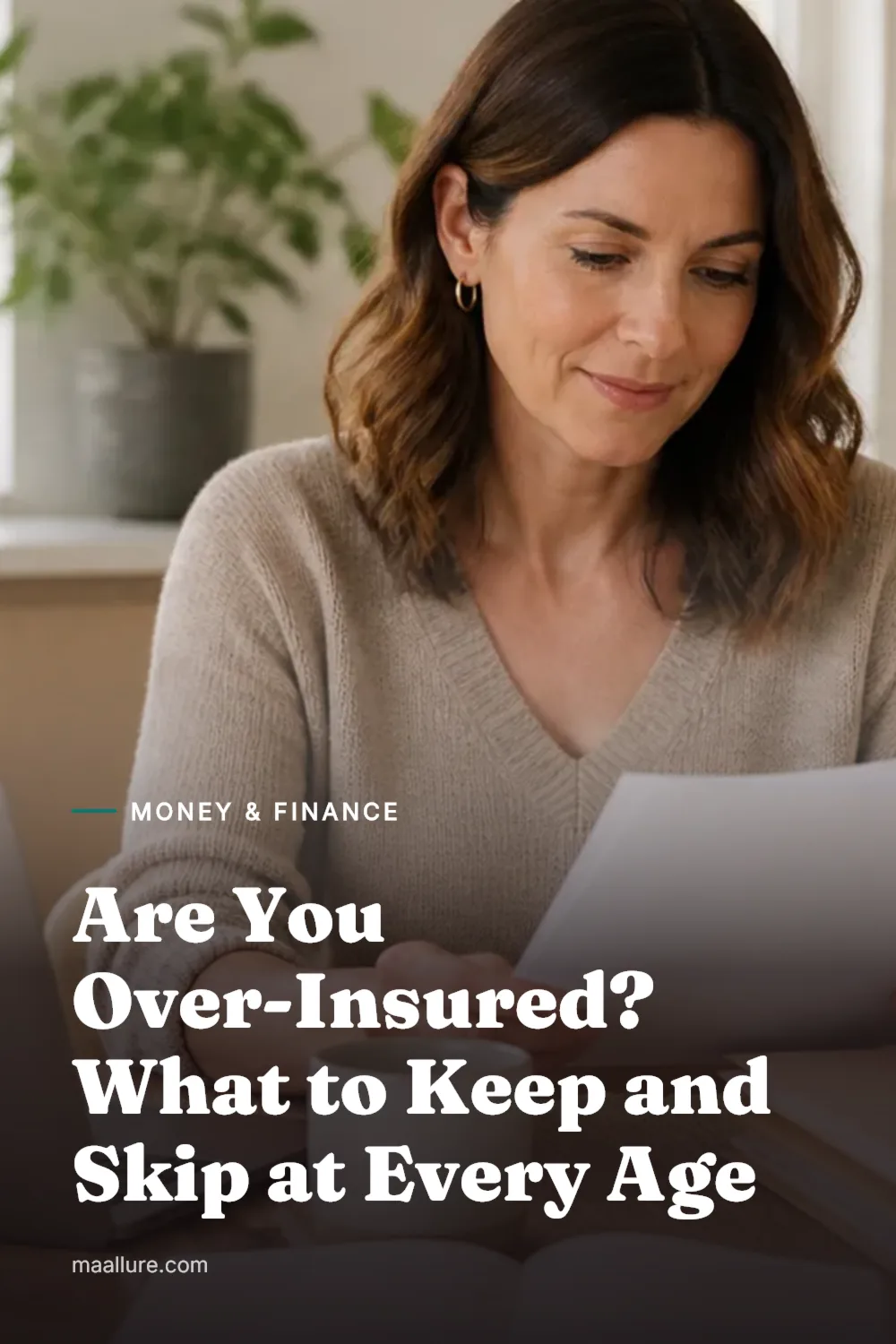 A woman reviewing insurance paperwork and a laptop at a bright kitchen table