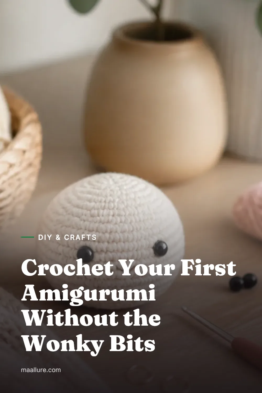 Small beginner amigurumi crochet toy on a craft table with yarn, hook and stitch markers